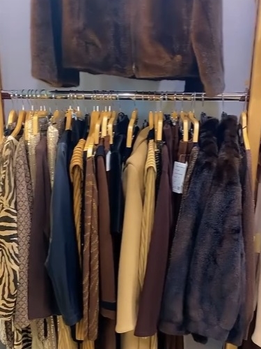 Perchero con variedad de pantalones de vestir y chaquetas de temporada.